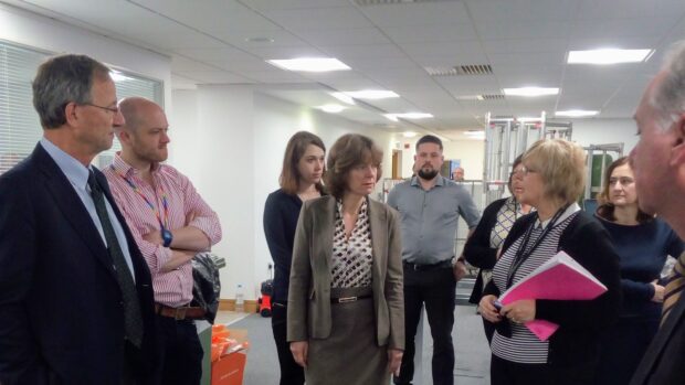 The HMCTS team show Tony Meggs (far left) and Alison Baptiste (centre) their work